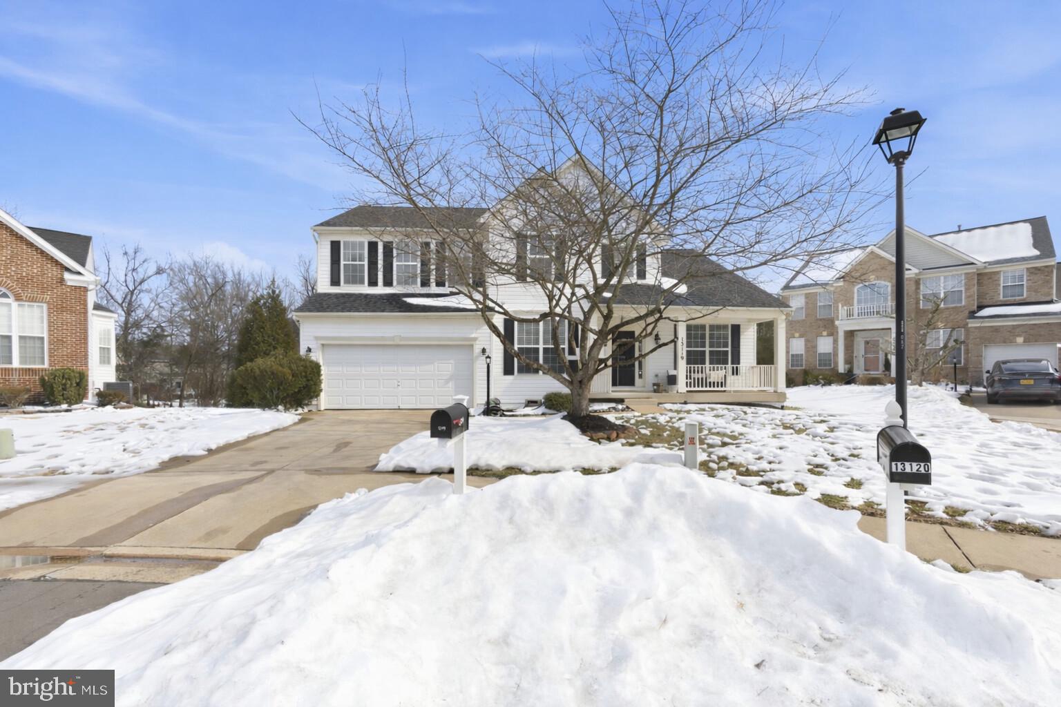 13119 Bigleaf Maple Court Gainesville, VA 20155 - Photo 2 of 36 a view of a house with snow on the road
