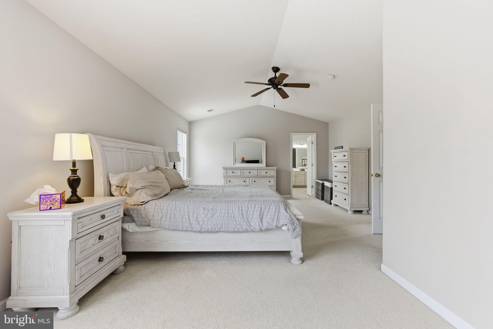 13119 Bigleaf Maple Court Gainesville, VA 20155 - Photo 22 of 36 a bedroom with a bed and a chandelier