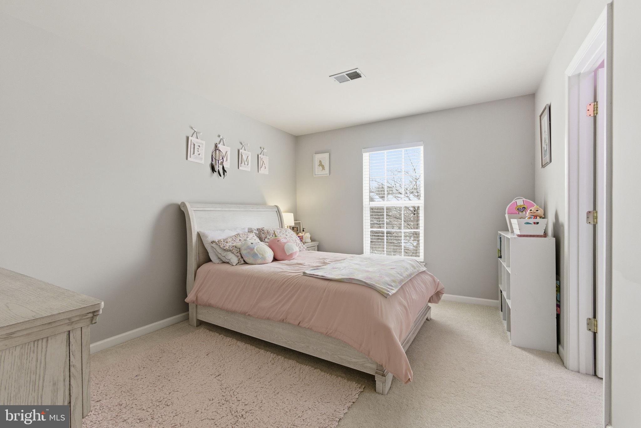 13119 Bigleaf Maple Court Gainesville, VA 20155 - Photo 27 of 36 a bedroom with a bed and a window