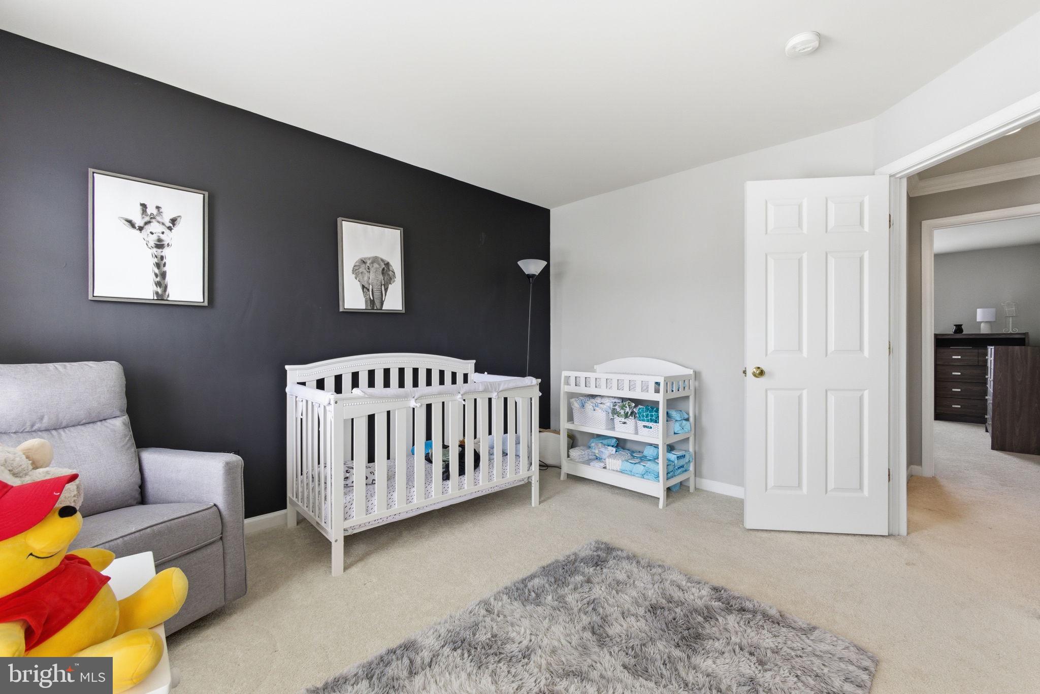 13119 Bigleaf Maple Court Gainesville, VA 20155 - Photo 29 of 36 a bedroom with furniture and a book shelf