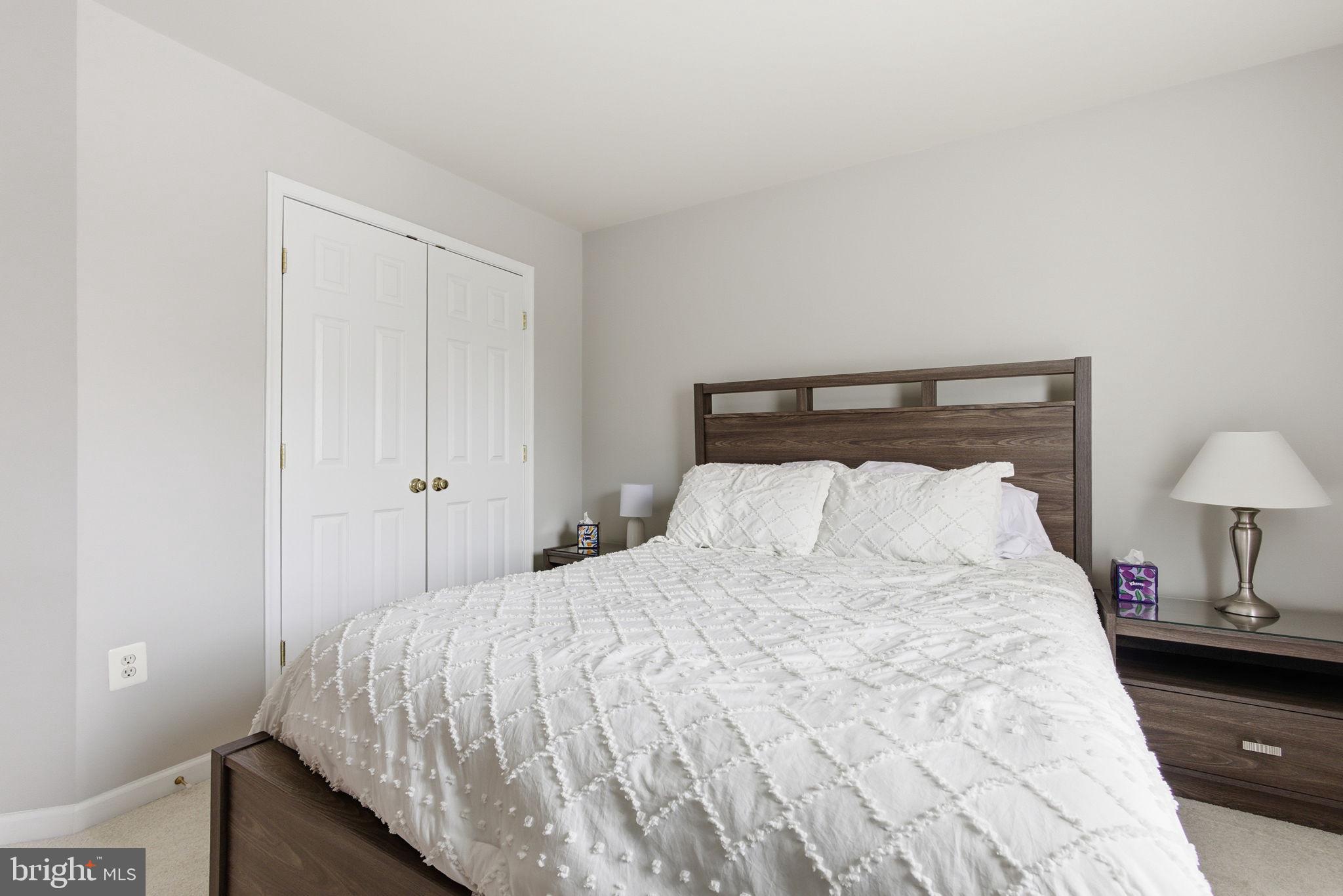 13119 Bigleaf Maple Court Gainesville, VA 20155 - Photo 31 of 36 a bedroom with a bed and two lamp