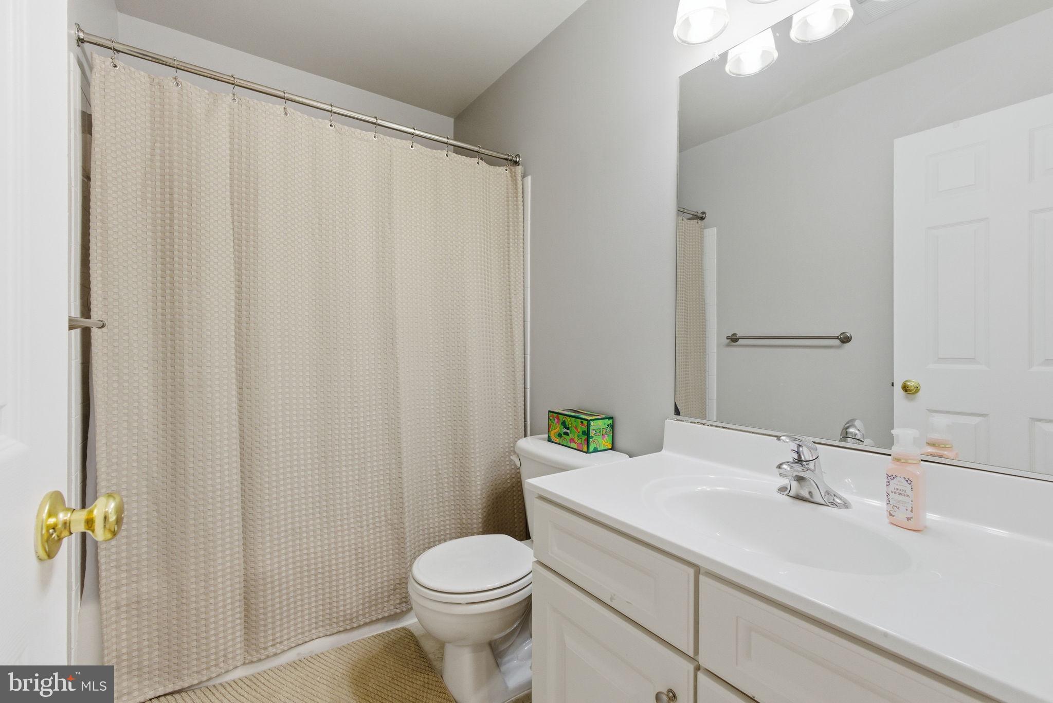 13119 Bigleaf Maple Court Gainesville, VA 20155 - Photo 32 of 36 a bathroom with a sink a toilet and a mirror