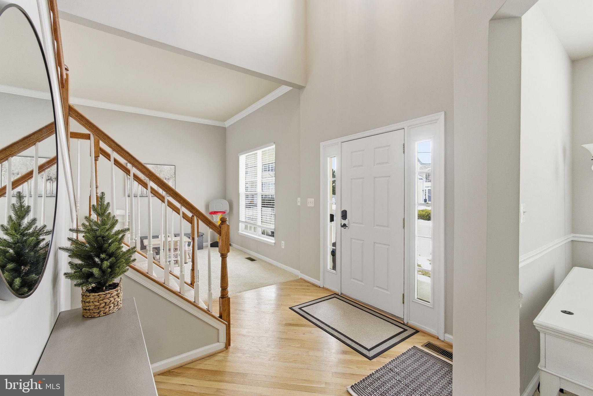 13119 Bigleaf Maple Court Gainesville, VA 20155 - Photo 4 of 36 a view of an entryway with wooden floor and stairs