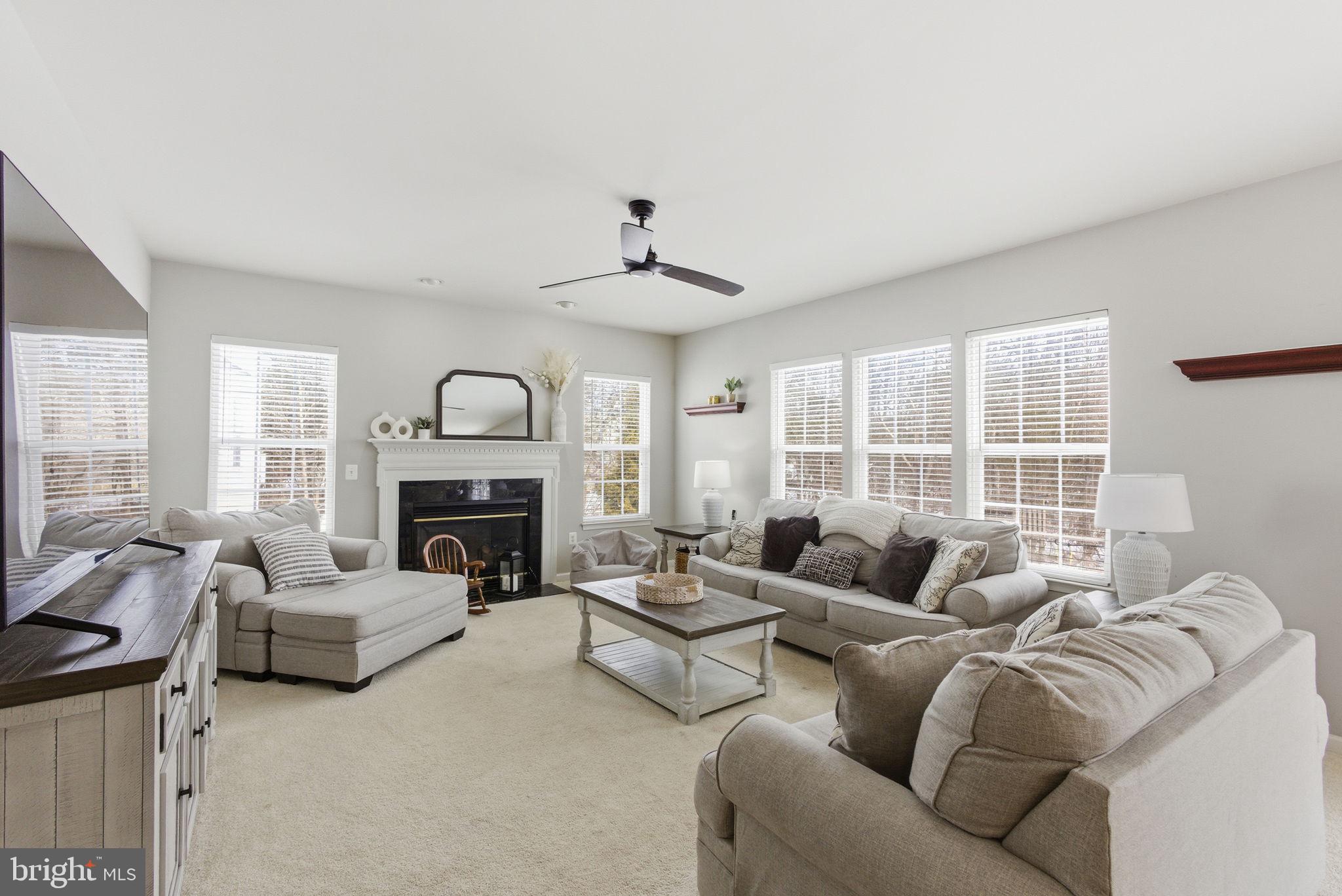 13119 Bigleaf Maple Court Gainesville, VA 20155 - Photo 7 of 36 a living room with furniture and a fireplace