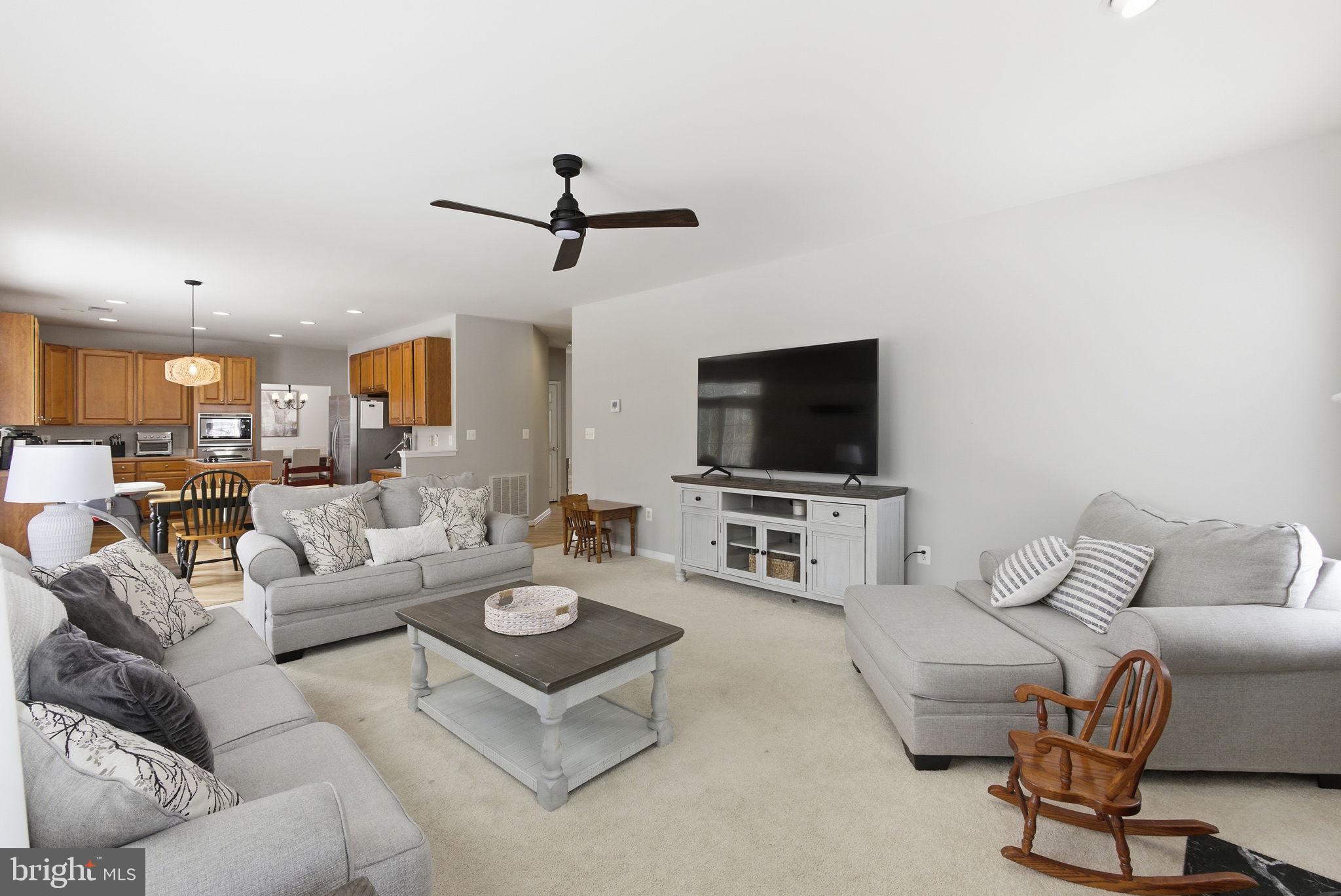 13119 Bigleaf Maple Court Gainesville, VA 20155 - Photo 8 of 36 a living room with furniture and a flat screen tv