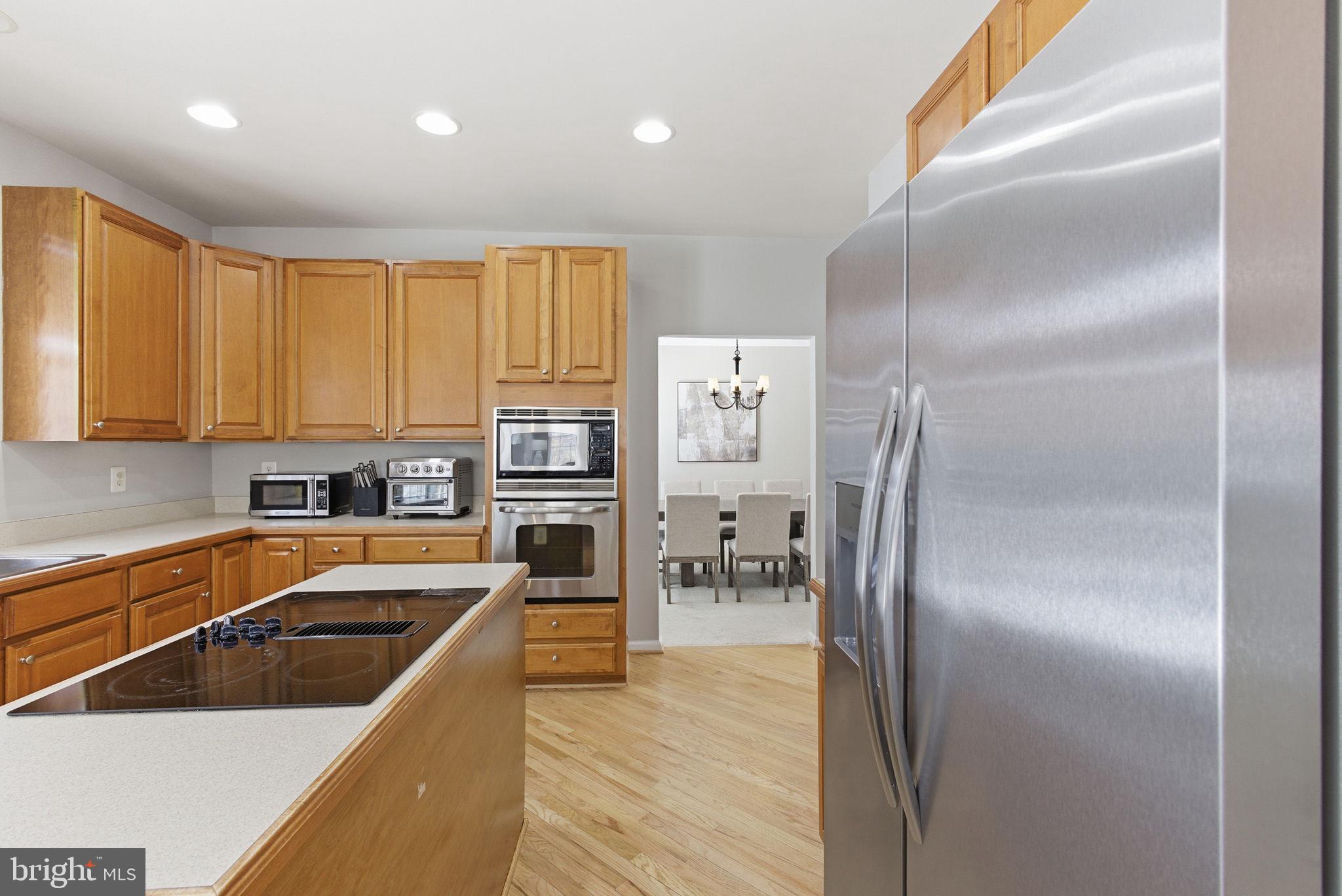 13119 Bigleaf Maple Court Gainesville, VA 20155 - Photo 9 of 36 a kitchen with cabinets and stainless steel appliances