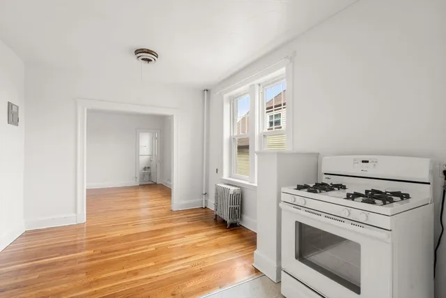 a kitchen with granite countertop a stove and a refrigerator