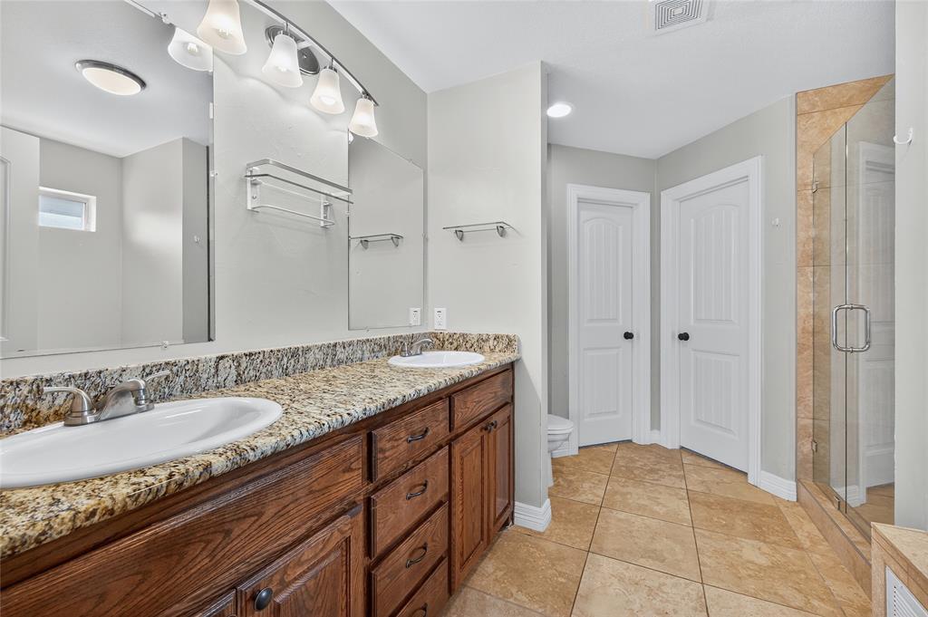 4814 Hilre Drive Sherman, TX 75092 - Photo 15 of 27 a bathroom with a granite countertop sink and a mirror