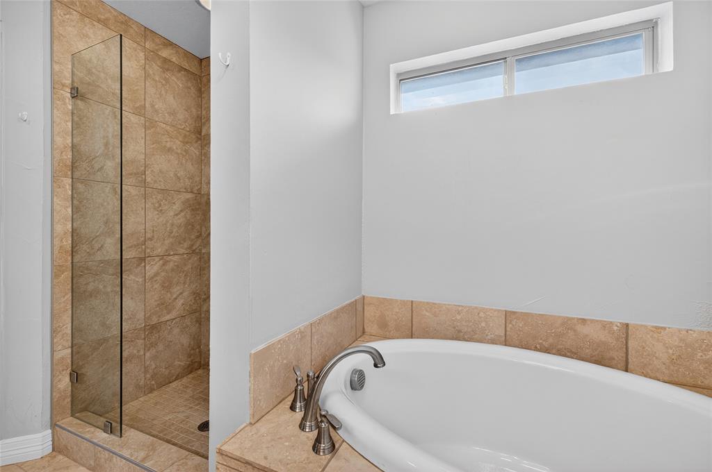 4814 Hilre Drive Sherman, TX 75092 - Photo 17 of 27 a bathroom with a bathtub and shower