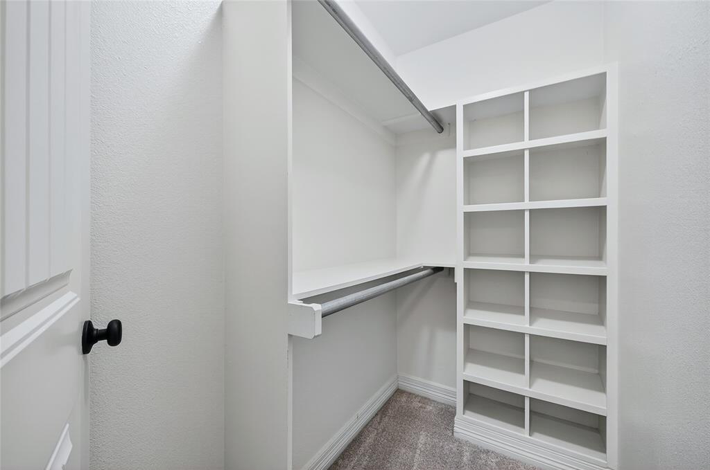 4814 Hilre Drive Sherman, TX 75092 - Photo 18 of 27 a view of walk in closet with empty racks
