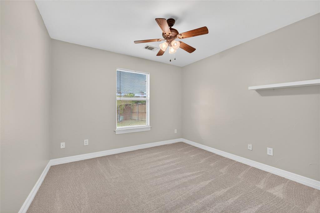 4814 Hilre Drive Sherman, TX 75092 - Photo 20 of 27 an empty room with a window and a fan