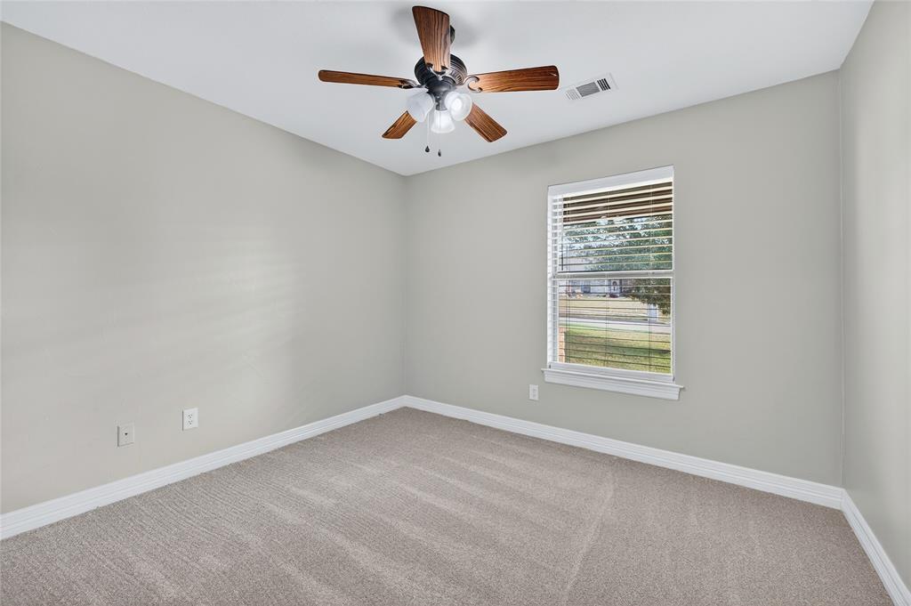 4814 Hilre Drive Sherman, TX 75092 - Photo 23 of 27 an empty room with a window and a ceiling fan