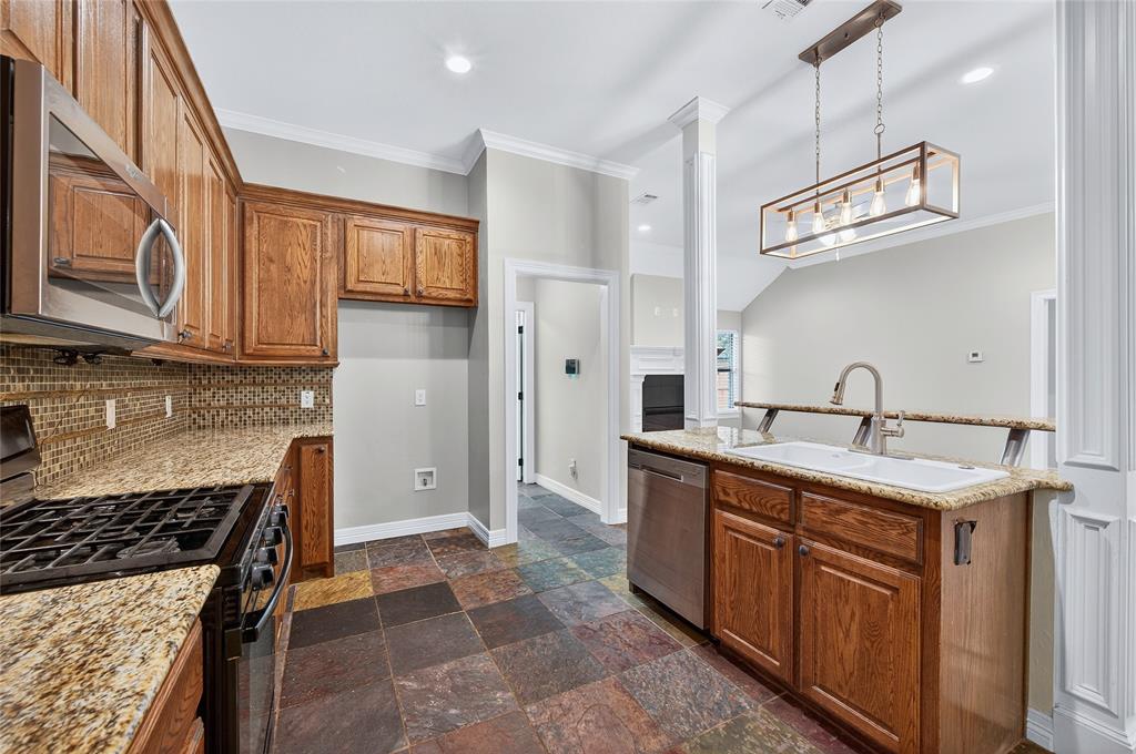 4814 Hilre Drive Sherman, TX 75092 - Photo 10 of 27 a kitchen with stainless steel appliances granite countertop a sink a stove and a refrigerator