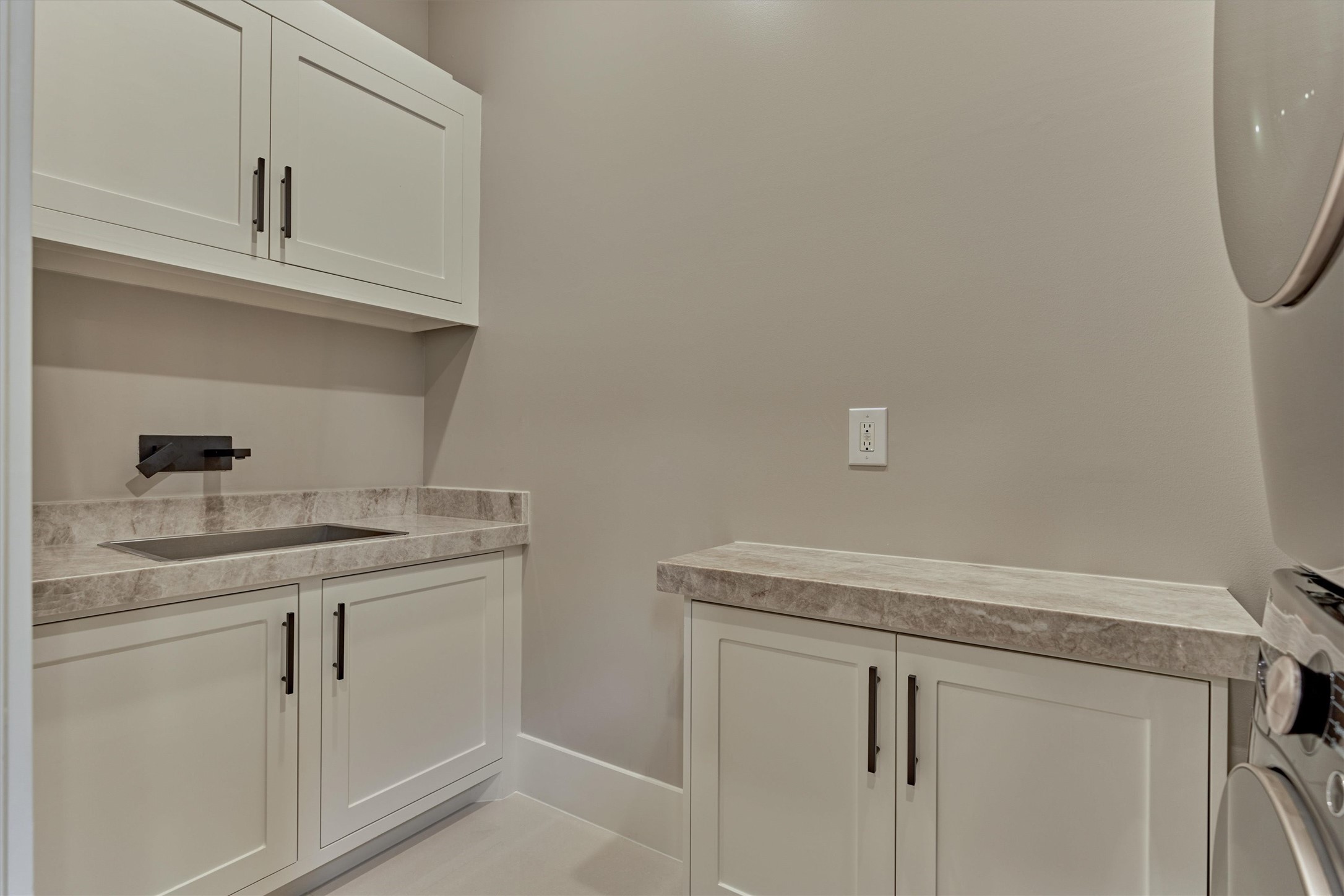 1907 Woerner Road Houston, TX 77090 - Photo 33 of 50 The private guest's quarters has its own laundry room with brand new washer and dryer set, wash sink, extra storage and Quartzite countertops.