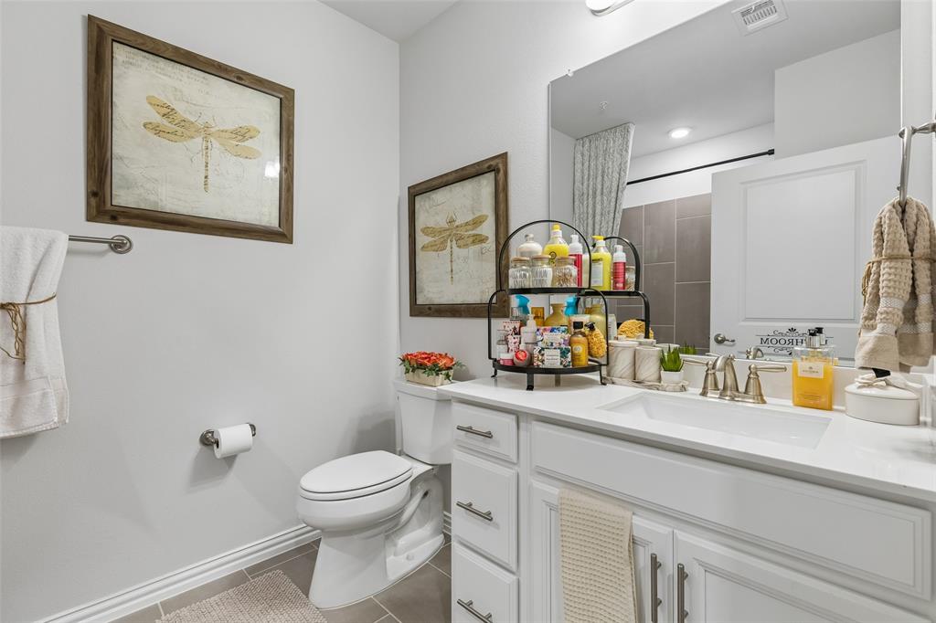651 Watters Road, Unit 7204 Allen, TX 75013 - Photo 28 of 40 a bathroom with a sink a toilet and a mirror