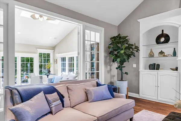 a living room with furniture fireplace and large windows