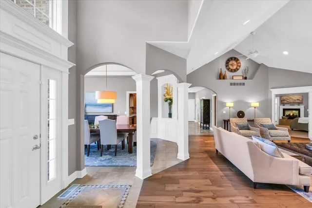 a living room with fireplace furniture and a large window