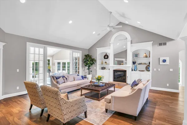 a living room with patio furniture and a potted plant