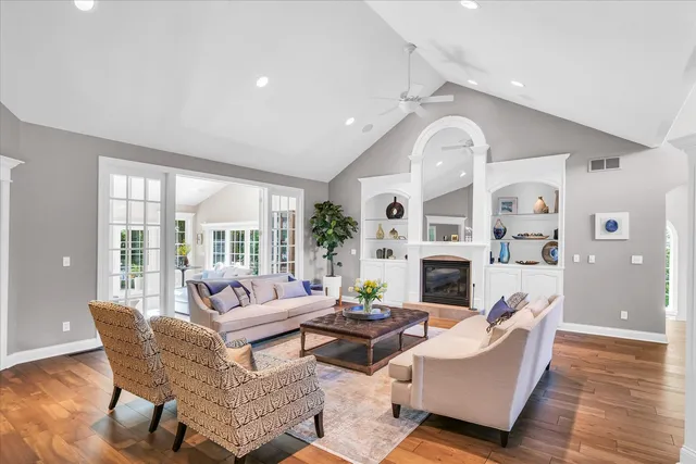 a living room with patio furniture and a potted plant