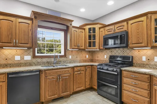 a view of kitchen with furniture and refrigerator