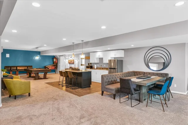 a kitchen with kitchen island granite countertop a sink a center island and cabinets