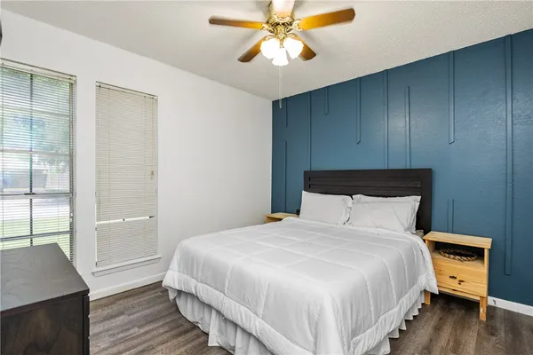a bedroom with a bed and wooden floor