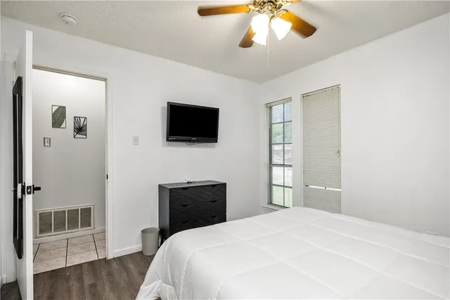 a bedroom with a bed and a flat screen tv