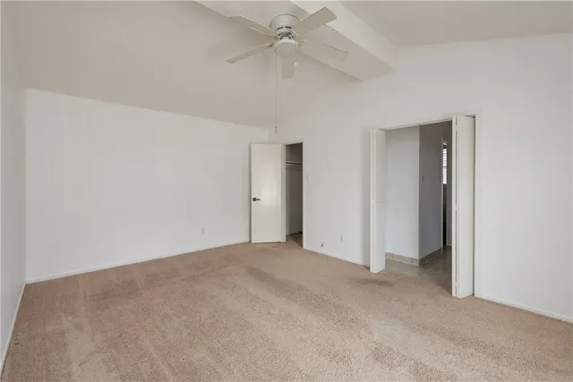 an empty room with fan and entrance