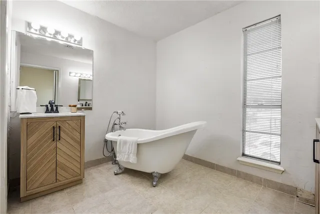 a spacious bathroom with a double vanity sink and a mirror
