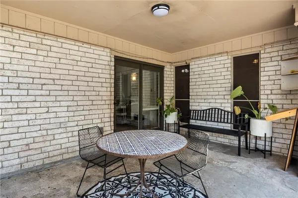 a balcony with table and chairs