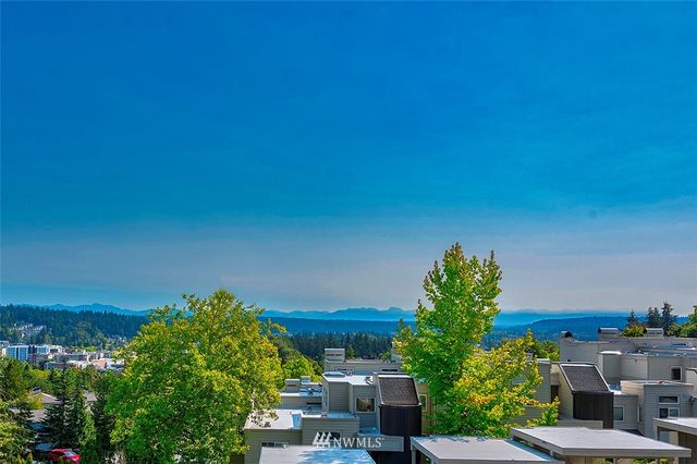 a view of backyard with swimming pool and seating area