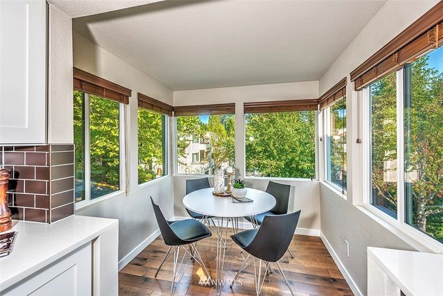 a living room with furniture a fireplace and potted plants