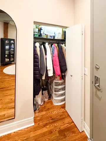 a dining room with stainless steel appliances kitchen island granite countertop a table chairs and a refrigerator