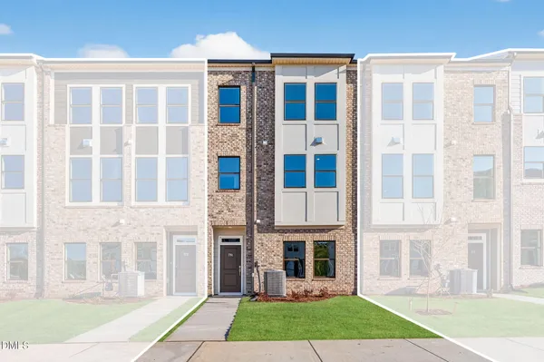 a view of a brick building with a yard