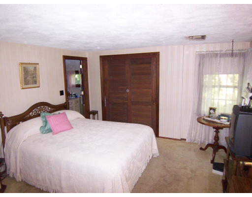 30 Hollywood Road Winchester, MA 01890 - Photo 9 of 12 a bedroom with a bed a chair and a large window