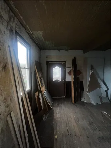 a view of a livingroom with wooden floor and stairs