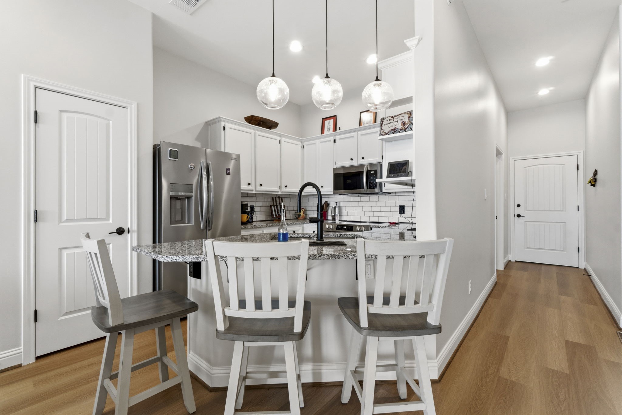 2 Key Harbour Conroe, TX 77356 - Photo 13 of 41 a kitchen with stainless steel appliances kitchen island granite countertop a dining table chairs and a refrigerator