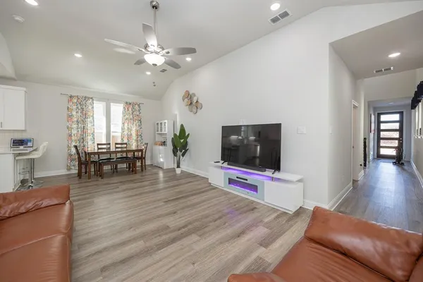 a view of a livingroom with furniture and a flat screen tv