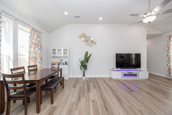 a view of a dining room with furniture and wooden floor