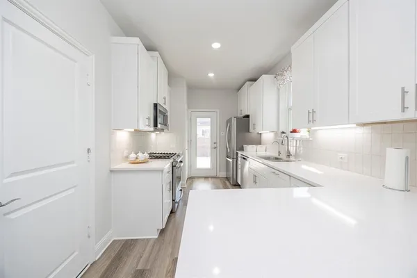 a stove top oven sitting inside of a kitchen