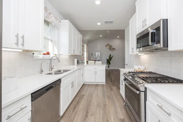 a bedroom with a large bed and a chandelier