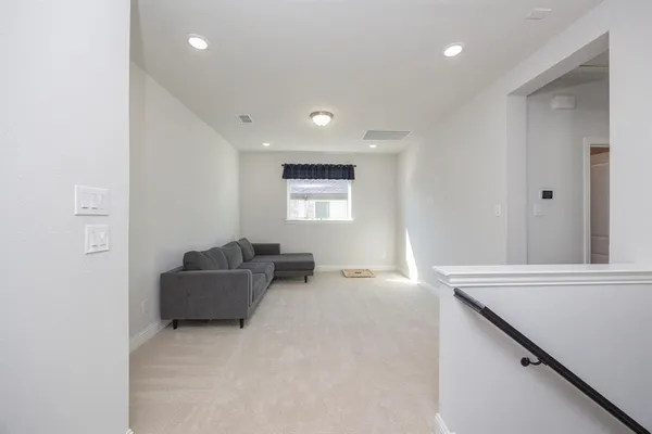 a view of a hallway with a living room