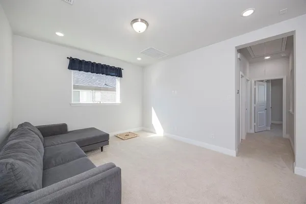 a living room with furniture and a sink