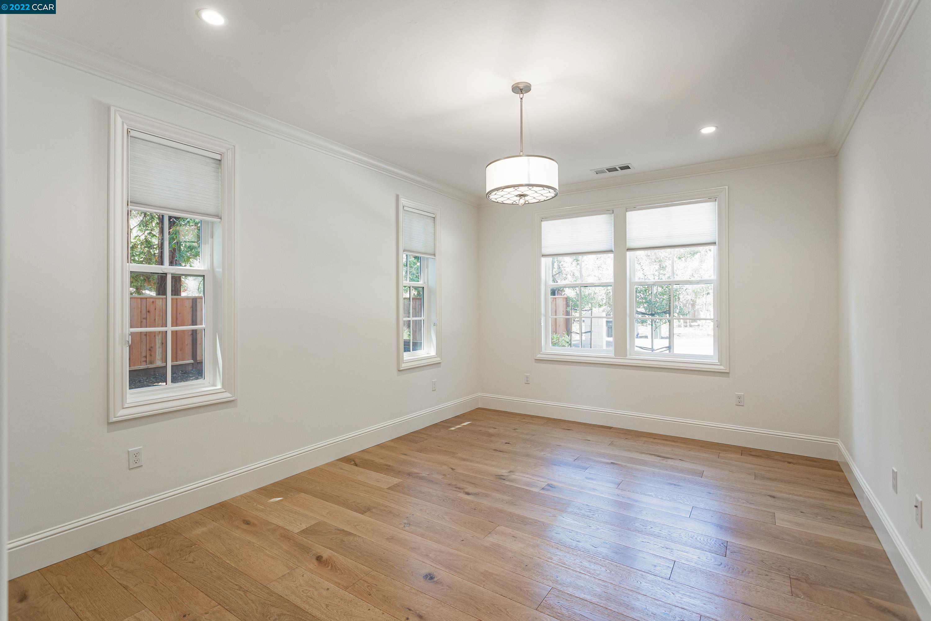 962 Reliez Station Lane Lafayette, CA 94549 - Photo 13 of 25 an empty room with wooden floor chandelier and windows