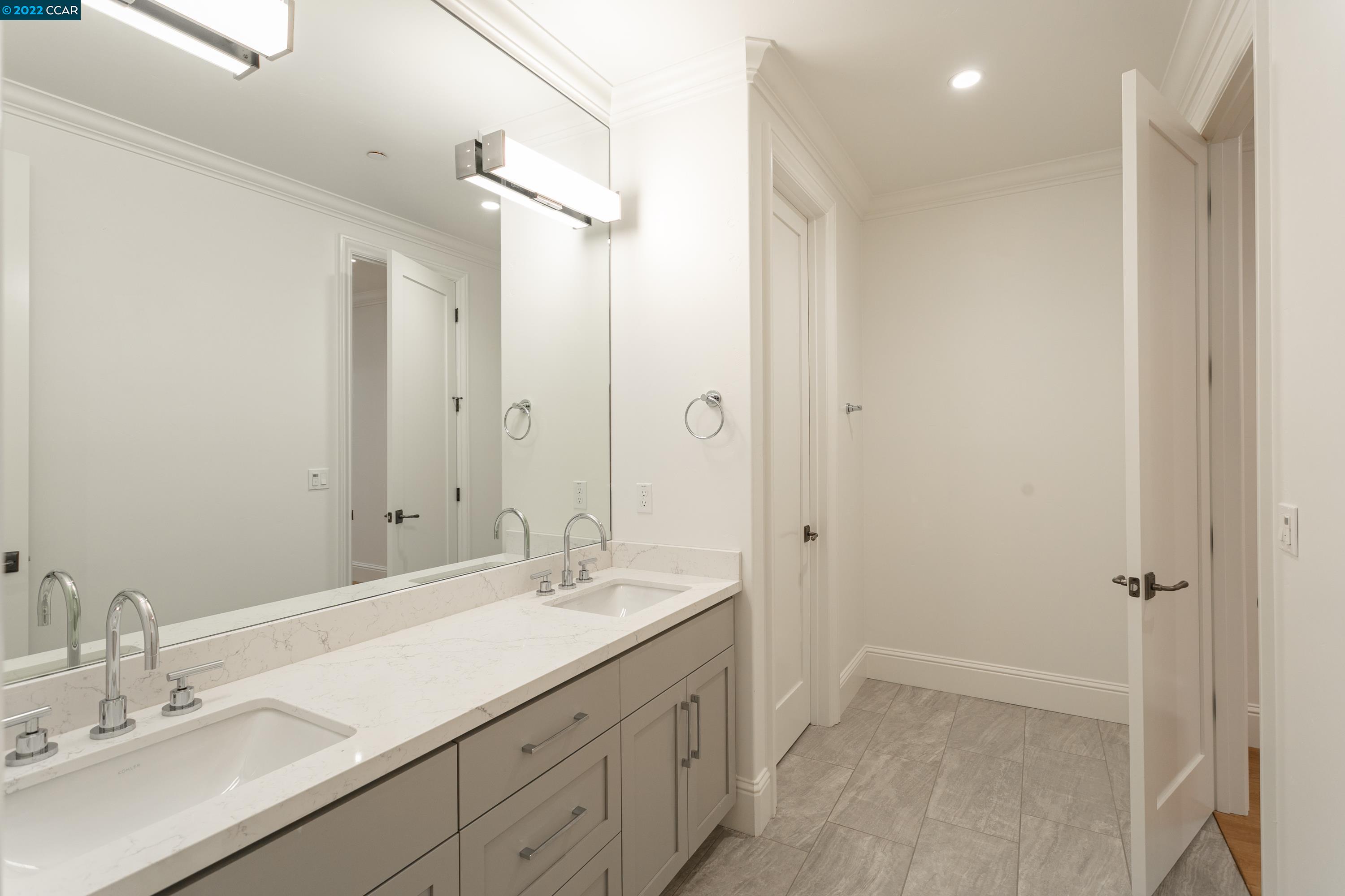 962 Reliez Station Lane Lafayette, CA 94549 - Photo 16 of 25 a bathroom with a double vanity sink a mirror and a shower