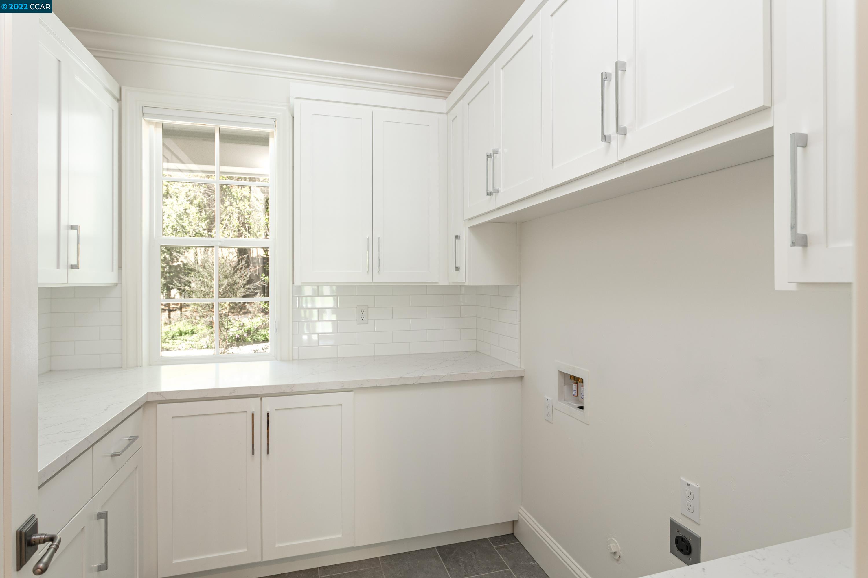 962 Reliez Station Lane Lafayette, CA 94549 - Photo 20 of 25 a view of a kitchen with white cabinets and a window