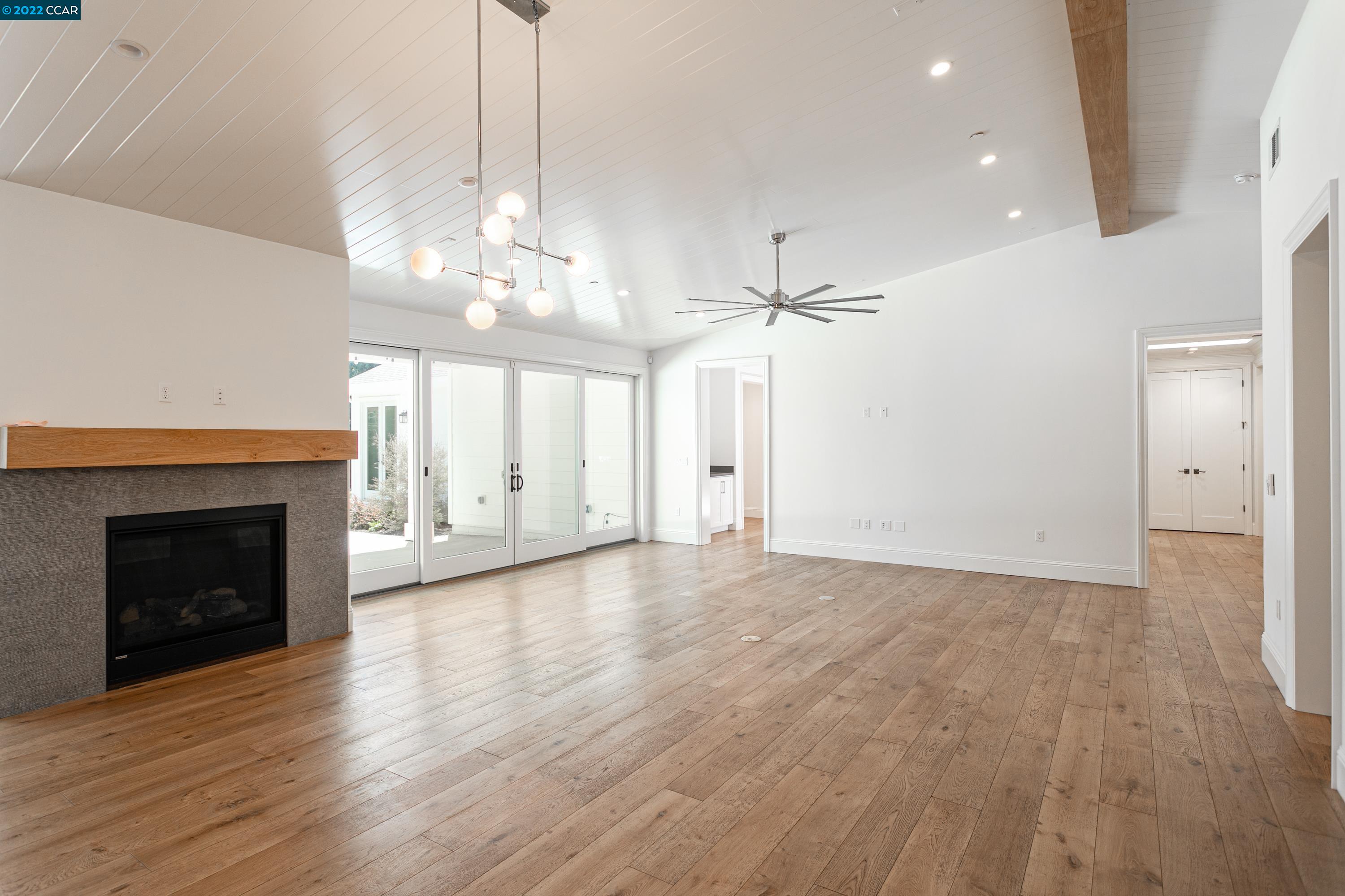 962 Reliez Station Lane Lafayette, CA 94549 - Photo 4 of 25 a view of an empty room with wooden floor fireplace and a window