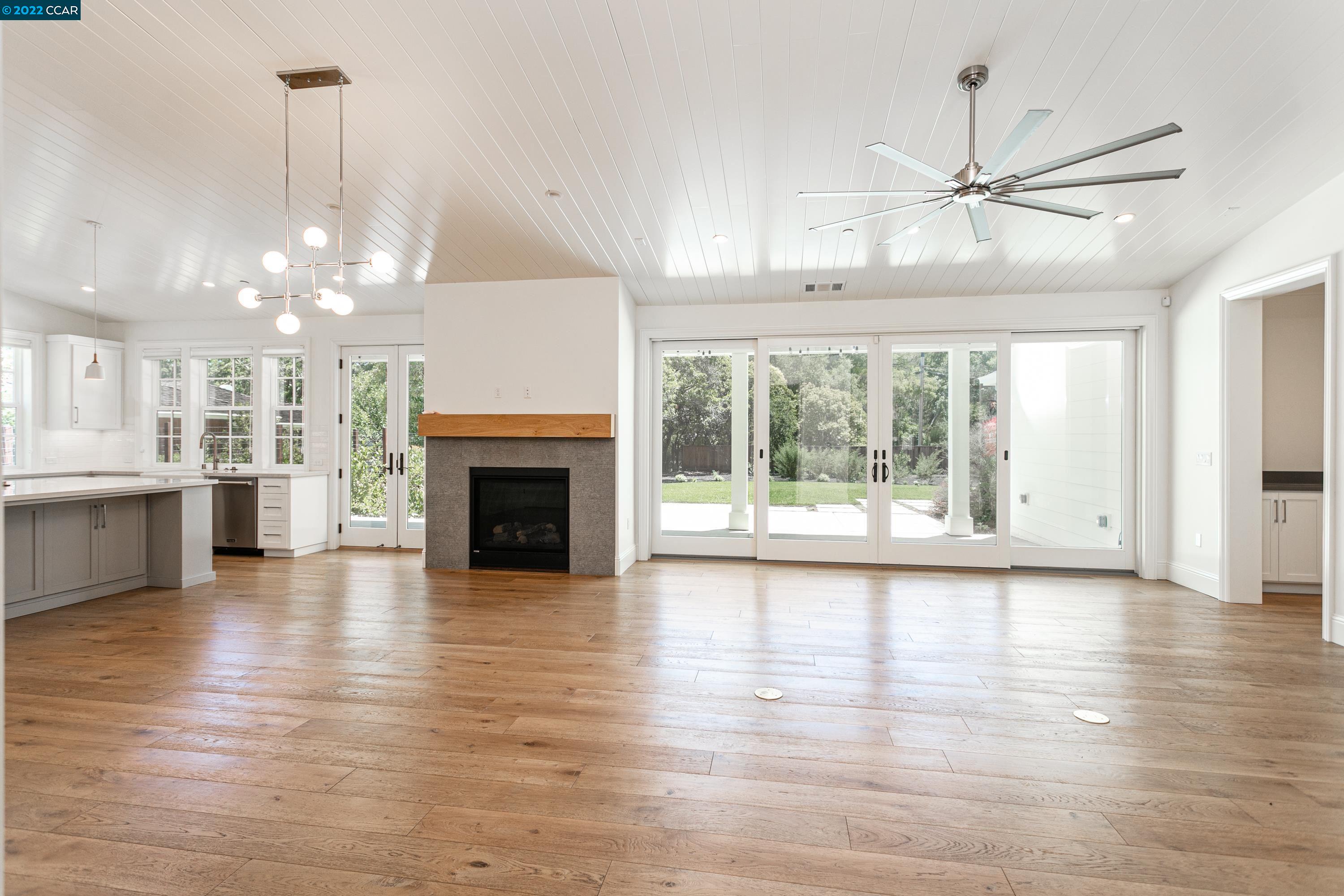 962 Reliez Station Lane Lafayette, CA 94549 - Photo 5 of 25 a view of a big room with wooden floor fireplace and windows