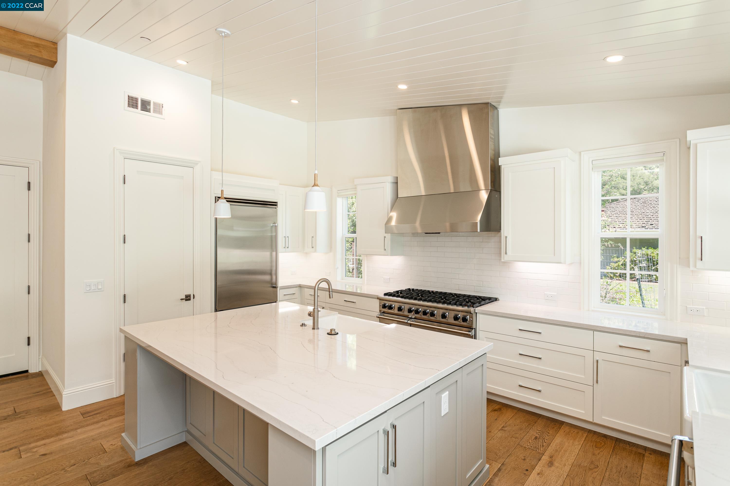 962 Reliez Station Lane Lafayette, CA 94549 - Photo 7 of 25 a kitchen with white cabinets stainless steel appliances and sink