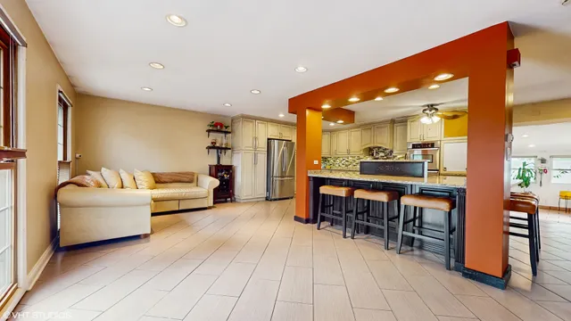 a kitchen with stainless steel appliances kitchen island granite countertop a sink and cabinets